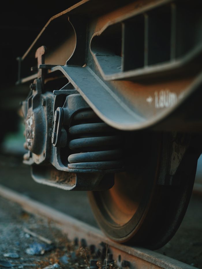 Services Detailed close-up of a train wheel on tracks with a focus on metal textures.
